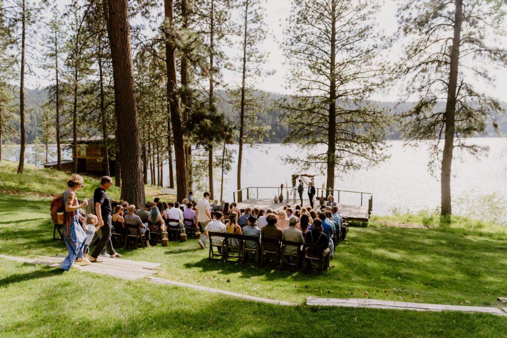 Outdoor spring wedding ceremony by the water near Spokane